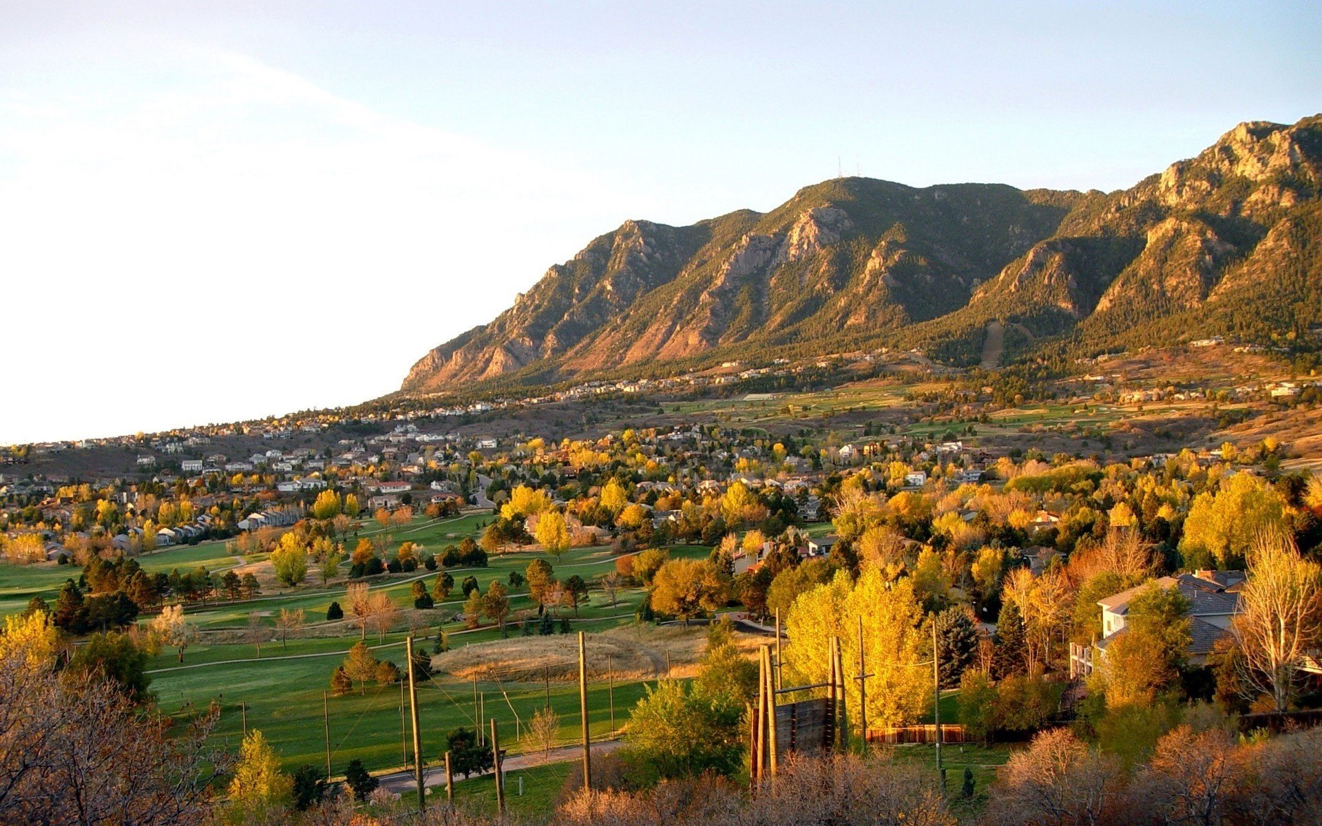 a small village houses mountains autumn leaves falling leaves golden time indian summer yellow leave