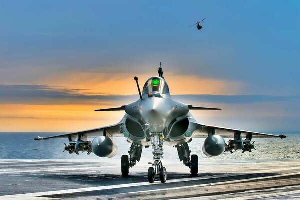 A military fighter jet on the background of sunset