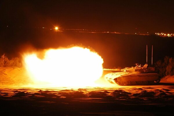 Fire at night. Military equipment is on fire