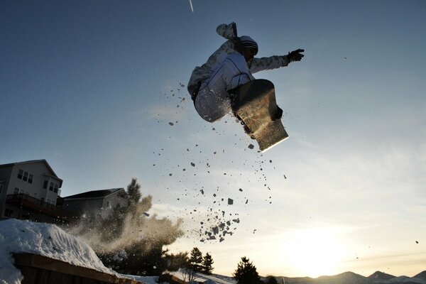 A snowboarder in a ski jump in the village