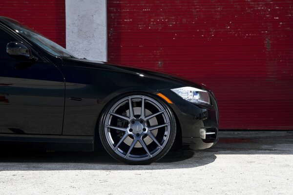 Black BMW on a red wall background