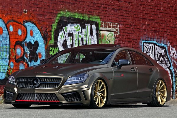 Mercedes-benz w218 and graffiti on a brick wall