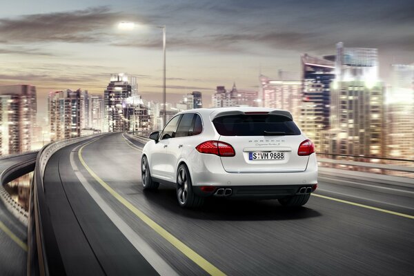 White Porsche Cayenne Driving on the road