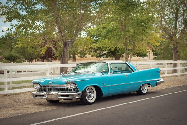 Retro car. Road and trees