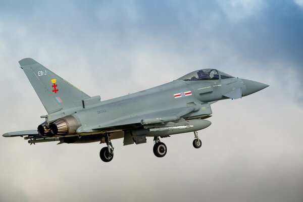 Fighter jet against the sky and clouds