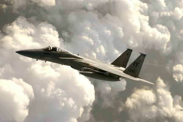 The e - 15 fighter performs a flight in the clouds