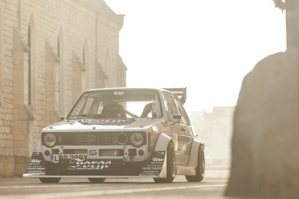 A white Volkswagen stands against the sun