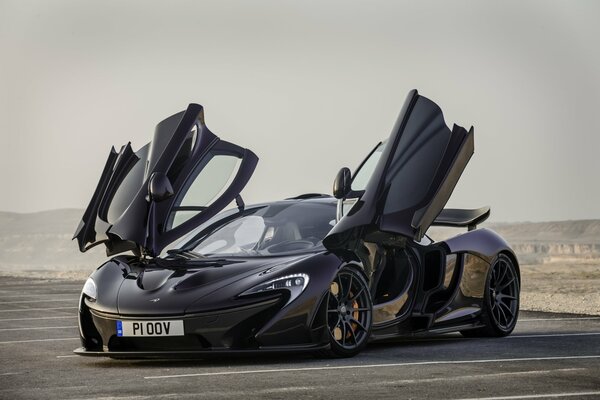 Black mclaren supercar with open doors