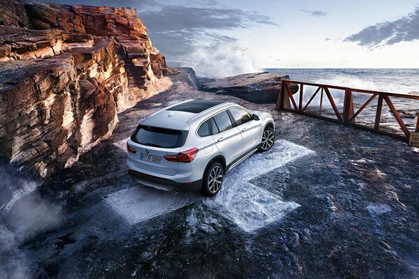 Car on the coast near the rocks