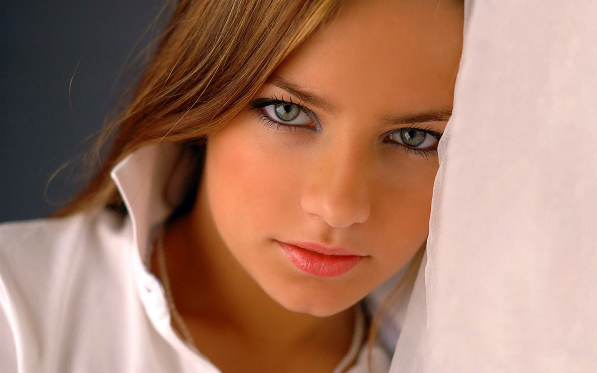 a woman girl brunette grey close up eyes face