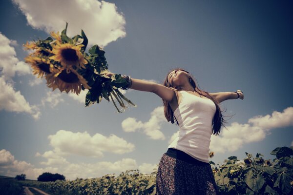 Girl in the field with a bouquet of sunflower joy sun