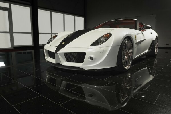 A white ferrari and its appendage on the floor