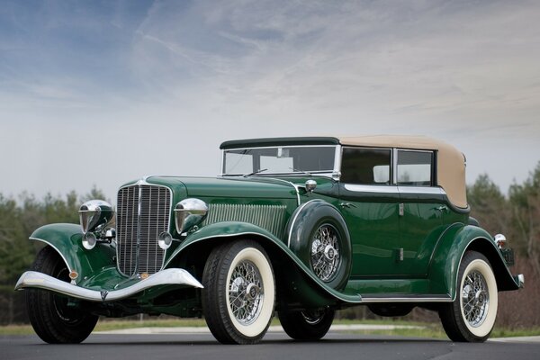 Green retro car with white tires