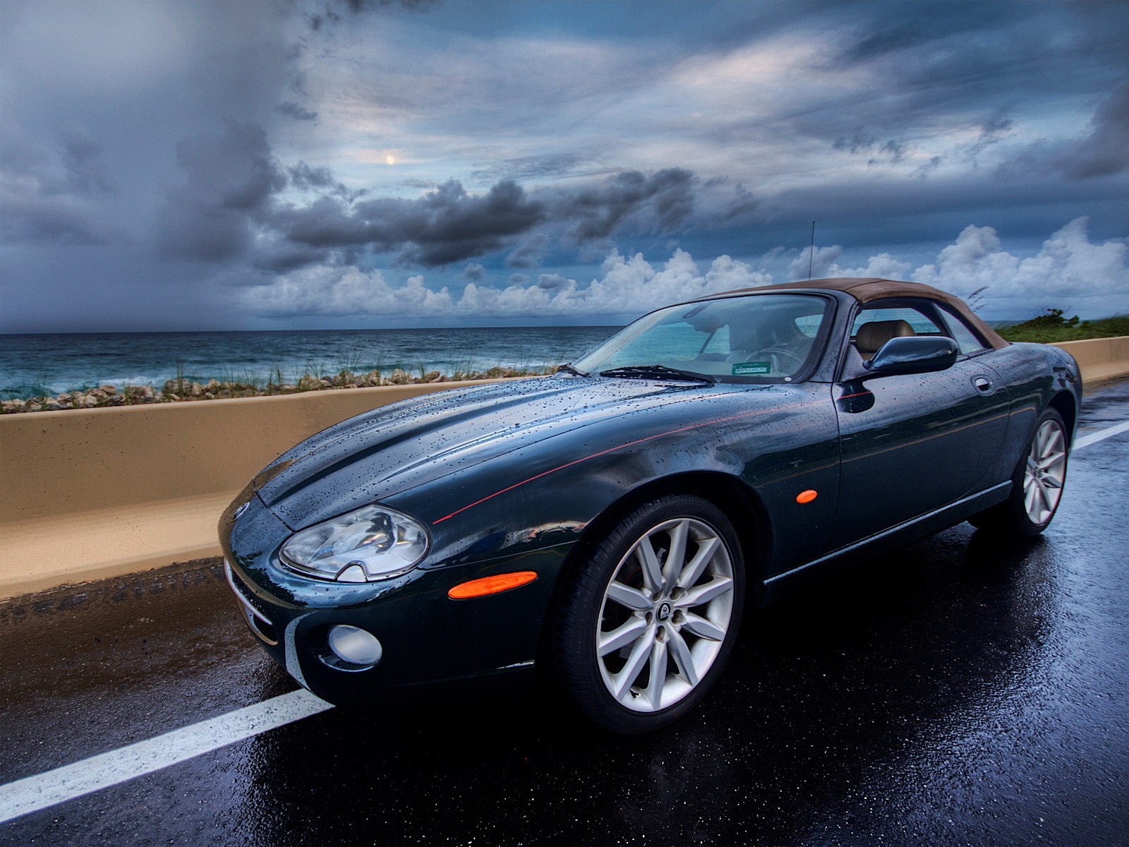 car road clouds sea