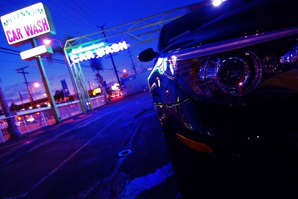 A beautiful car is driving on a neon highway