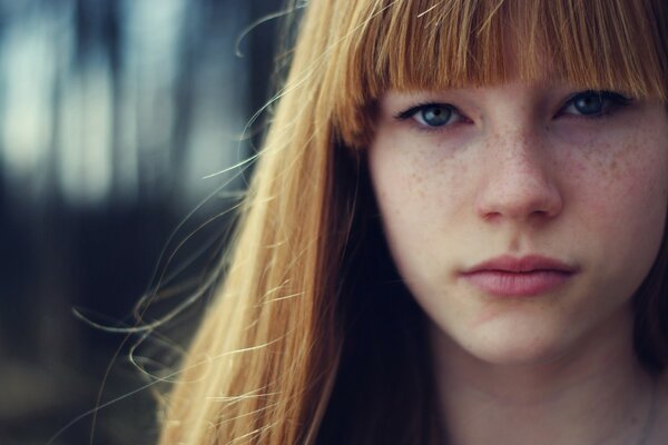 The freckles on the girl s face are very pretty