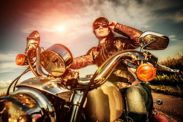 Girl on a motorcycle with glasses