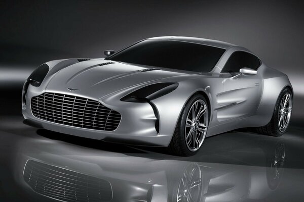 Silver Aston Martin with its own reflection on the floor