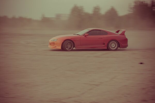 Dusty sports car on the highway