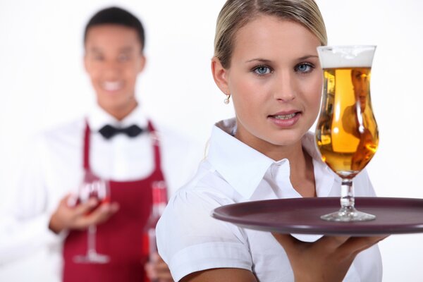 A waiter girl with a glass of beer