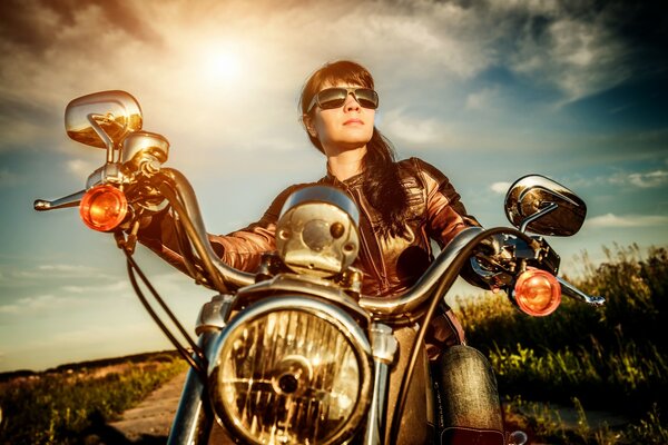 Girl on a motorcycle wearing sunglasses