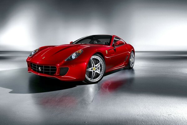 Red ferrari with alloy wheels on a white background