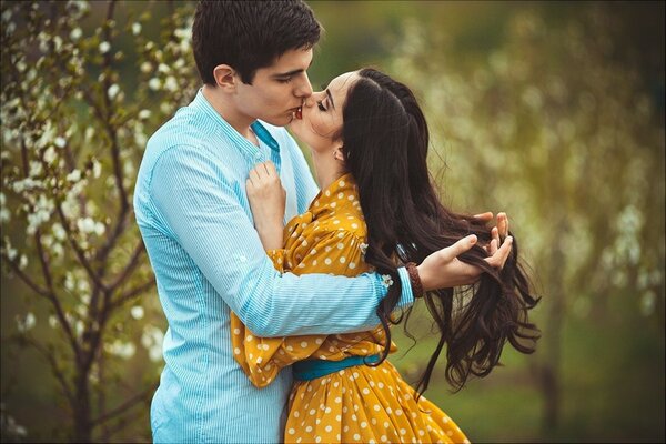 Photo shoot of lovers. A kiss against the background of nature