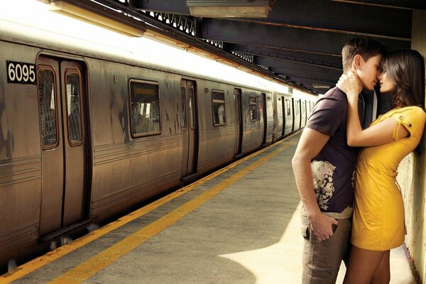 A couple in love kissing near the train