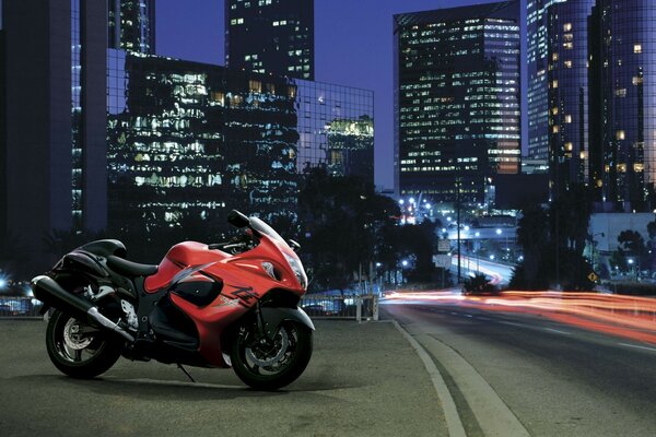 A sports motorcycle on the background of a sparkling metropolis