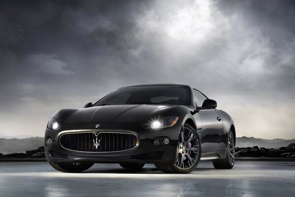 Black Maserati granturismo-x with headlights on