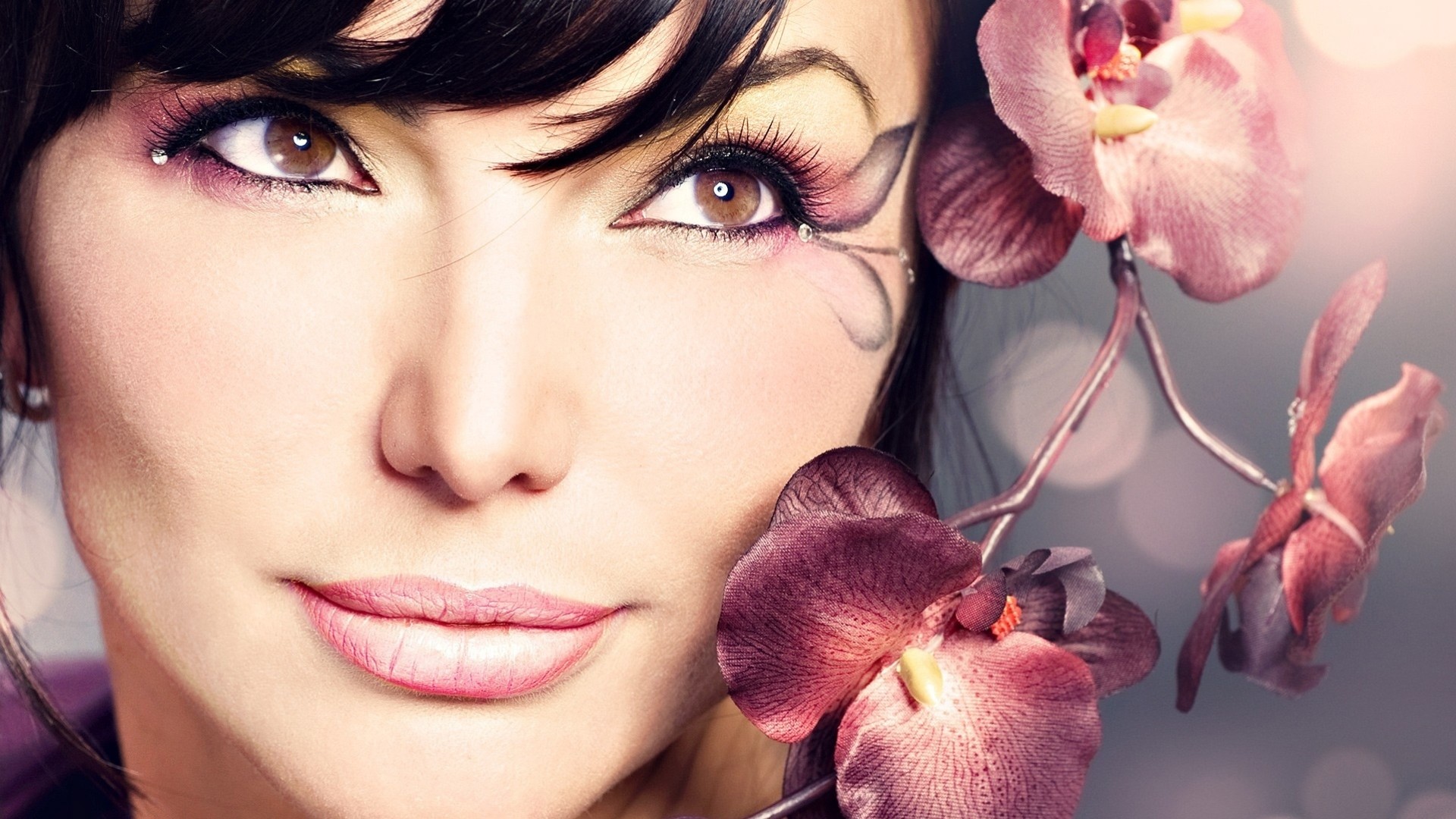 a woman girl brunette grey close up flower pink face