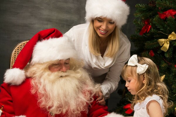 Girl with Santa Claus and snow maiden