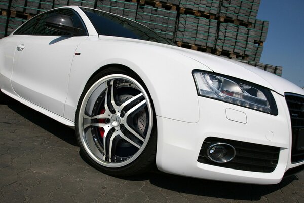 White audi photo from the side of the wheel