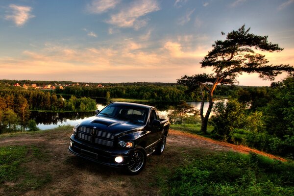 Against the background of a wild landscape - a mighty black jeep