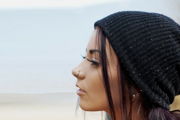 The girl in the hat. Model with piercing