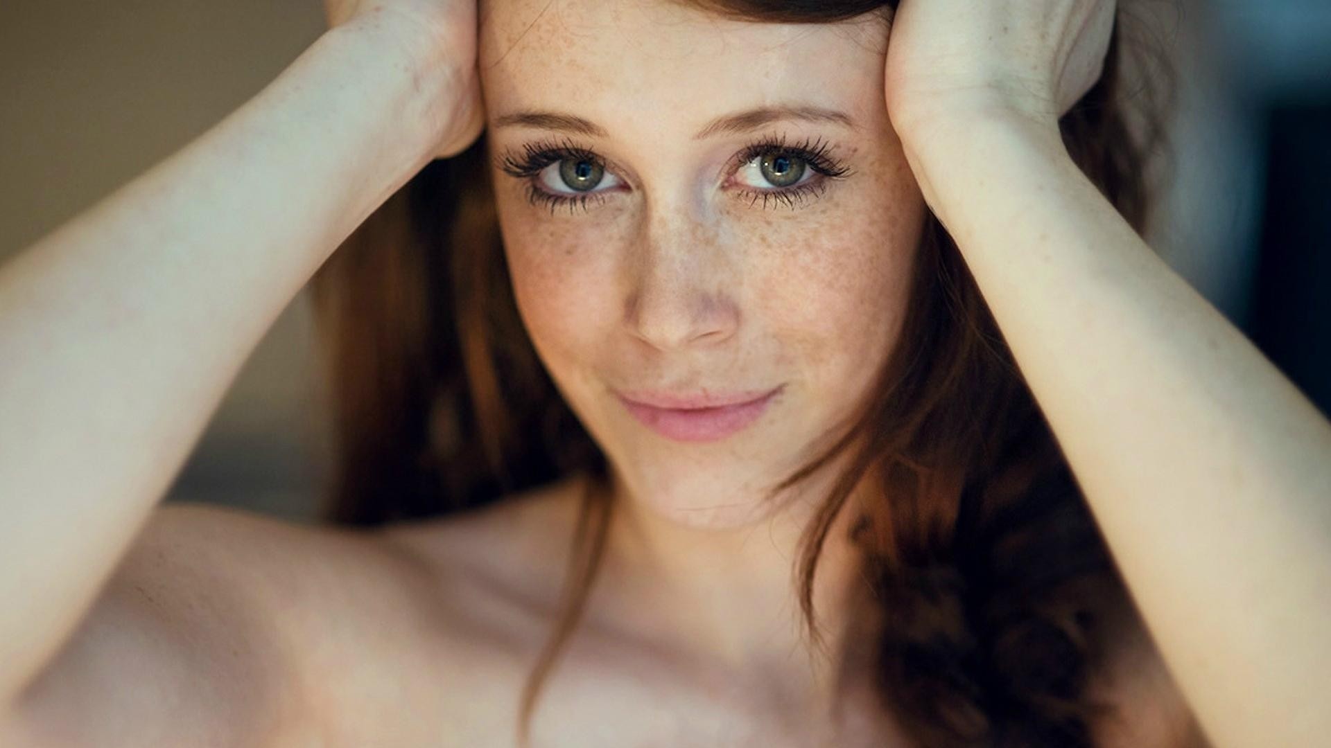 a woman girl brunette grey close up face