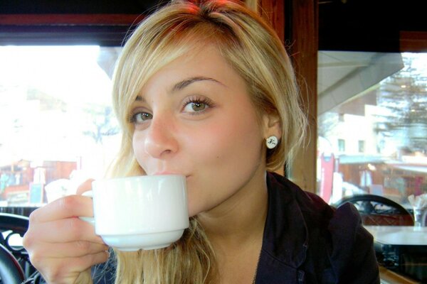 The actress drinks coffee. A picture in a coffee shop