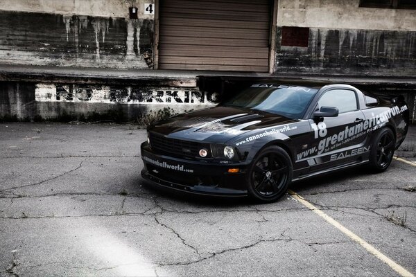 A black car on an incomprehensible gray background