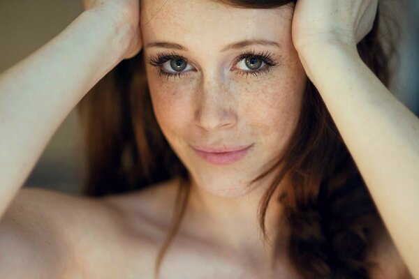 Girl with freckles posing on camera