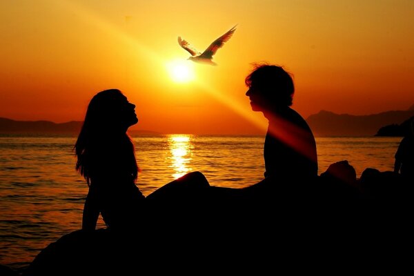 Crimson sunset on the seashore with your loved one