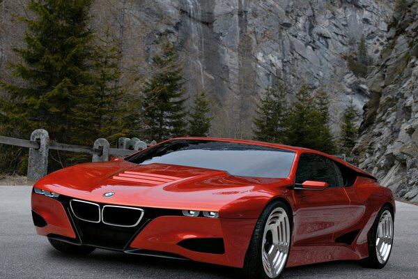 Photo de bmw rouge sur fond de rochers