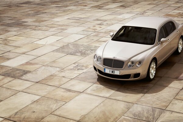 White Bentley on an empty square