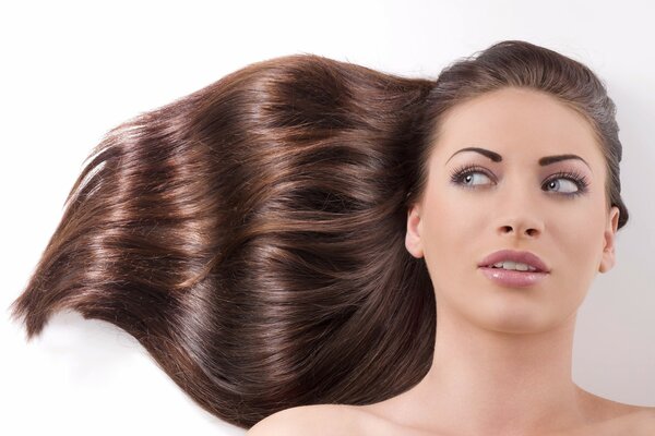 Brown-haired woman close-up on a white background