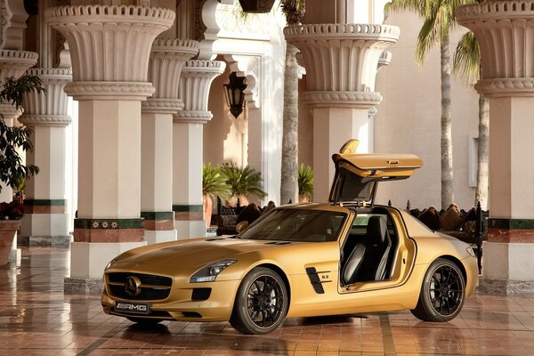 Golden mercedes amg sls63 in the hall with columns