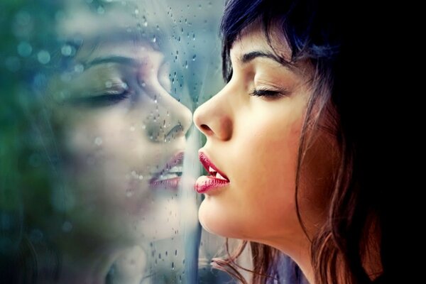 Brunette breathing on glass in rainy weather