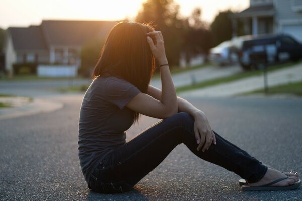 A girl with long hair on the asphalt