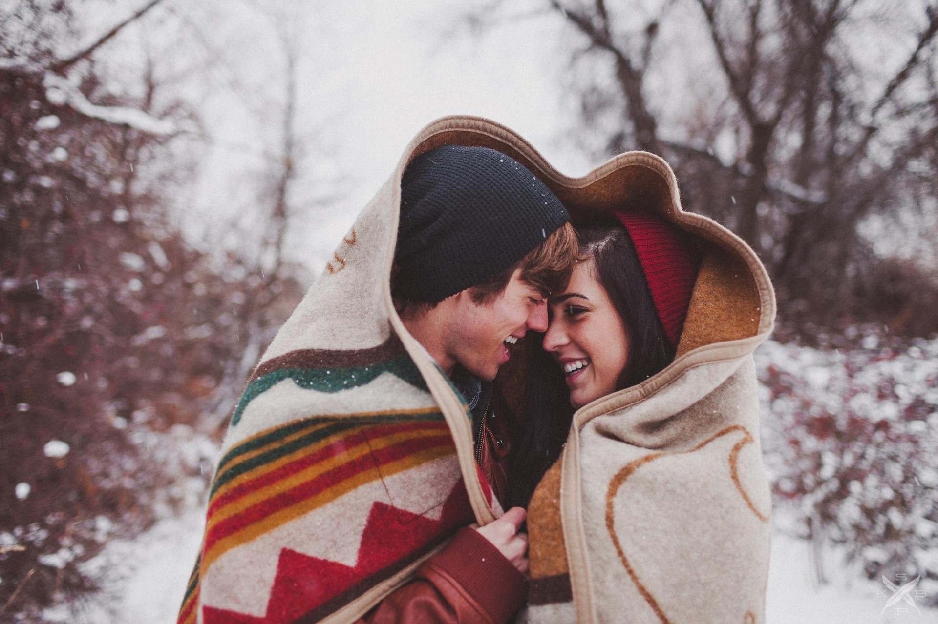 happiness cool together snow man and woman winter bundled up blanket