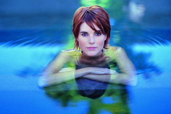 Sexy woman in a pool with water