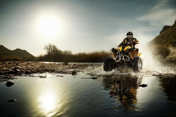 ATV monta en un charco de salpicaduras