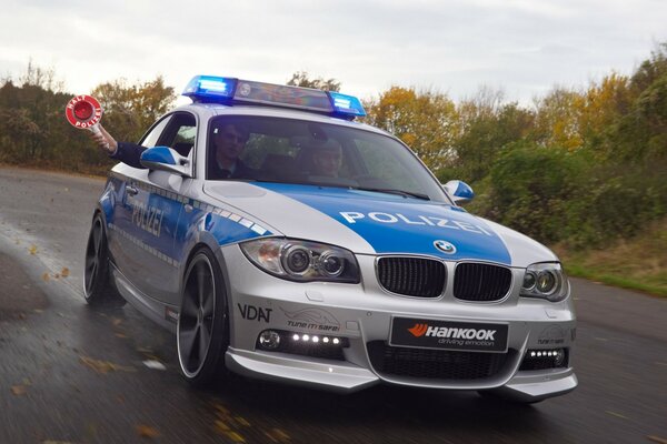 A police gray-blue car on an autumn road